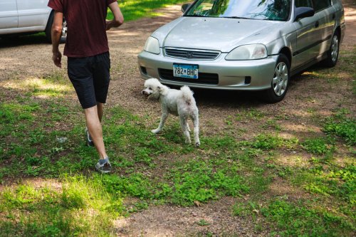 Elliot in front of the car
